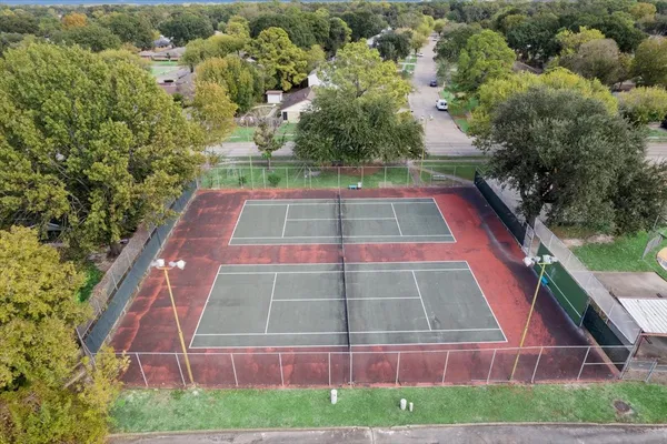 a view of a tennis court with a small yard
