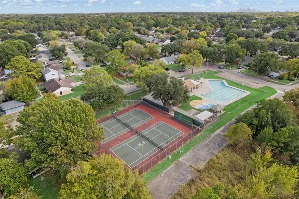 an aerial view of residential houses with outdoor space and street view