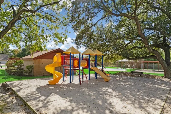 a view of outdoor space with playground and green space