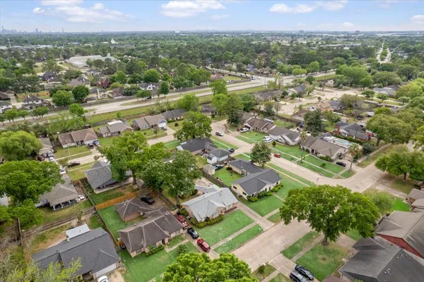 an aerial view of residential houses with outdoor space and river