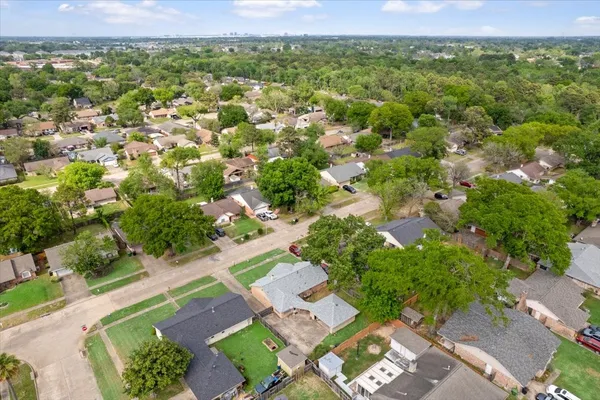 an aerial view of residential houses with outdoor space