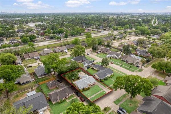 an aerial view of residential houses with outdoor space and river