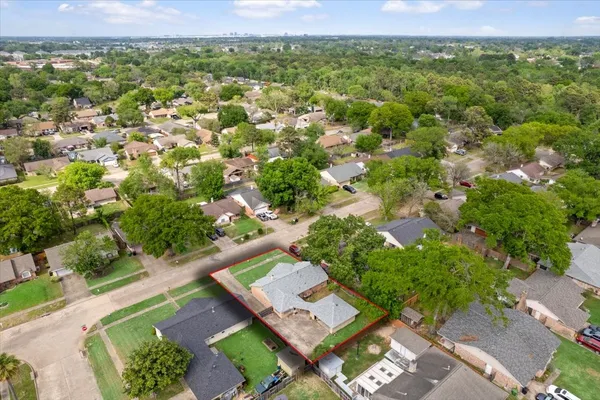 an aerial view of residential houses with outdoor space