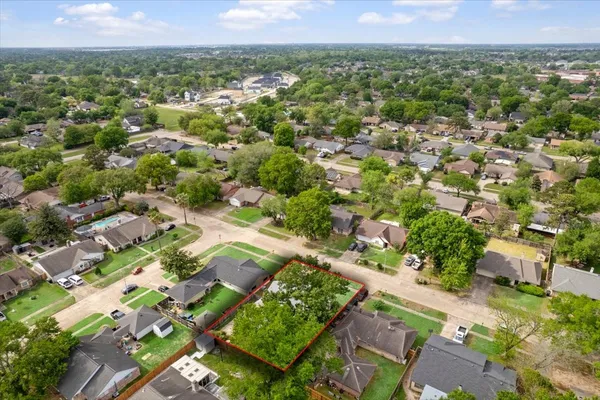 an aerial view of residential houses with outdoor space