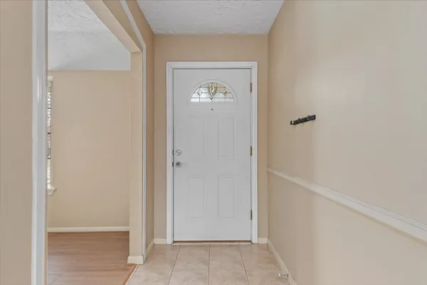 a view of an entryway with wooden floor