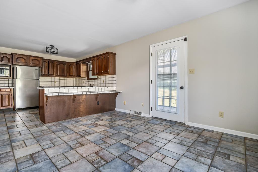 776 Glendale Road Jonesborough, TN 37659 - Photo 13 of 40 Kitchen-Dining, Side door to porch