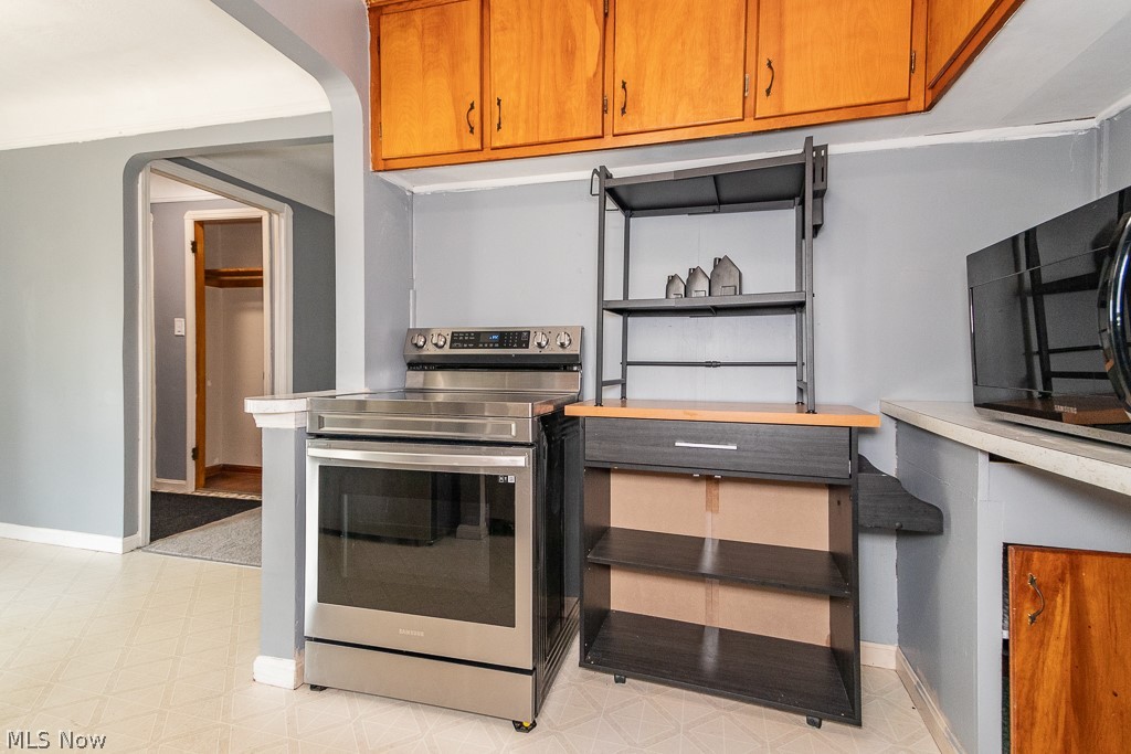 4210 Redfern Road Parma, OH 44134 - Photo 12 of 46 Kitchen with light tile patterned flooring and stainless steel range with electric cooktop