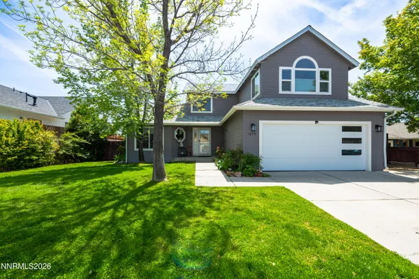 a front view of a house with a yard and garage