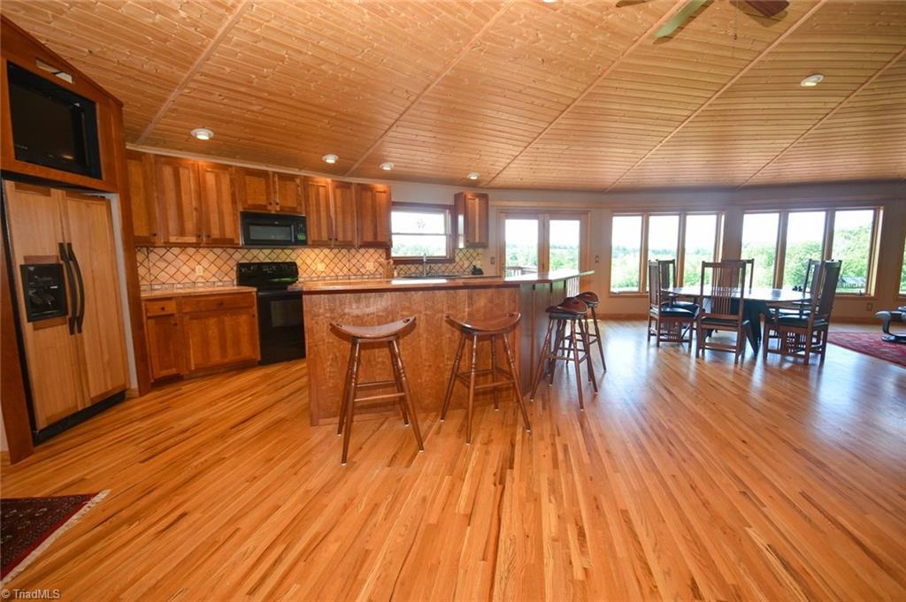 1047 Radhas Way Sandy Ridge, NC 27046 - Photo 5 of 30 First view of the home and the radial roof system - supports only on the outside walls. The hardwood floors on the main level are narrow strips all running in the same direction for a dramatic effect.