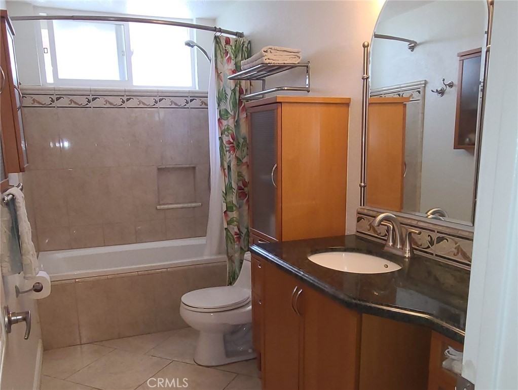 719 Cobb Avenue Placentia, CA 92870 - Photo 13 of 18 a bathroom with a granite countertop sink toilet and shower