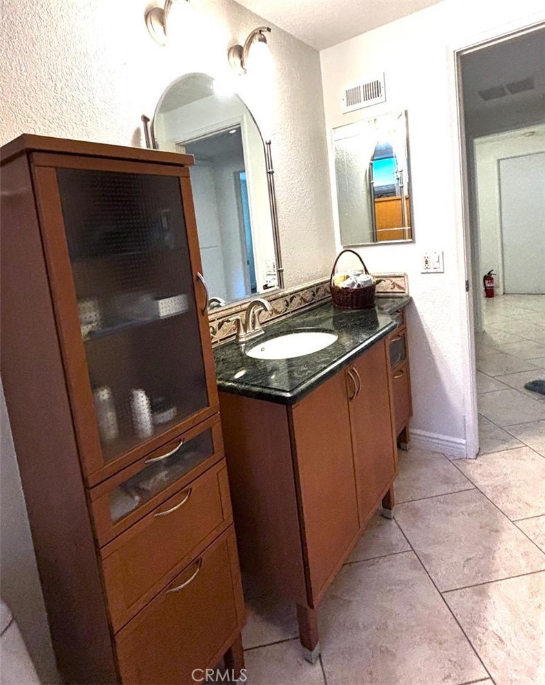 719 Cobb Avenue Placentia, CA 92870 - Photo 14 of 18 a bathroom with a sink a mirror and a shower