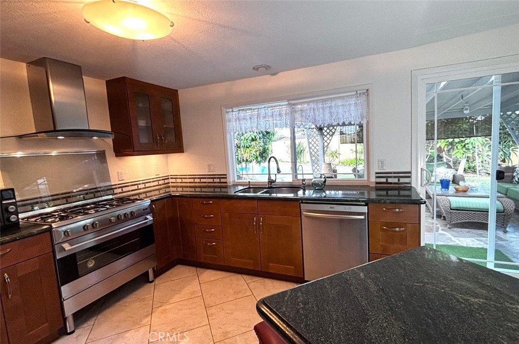 719 Cobb Avenue Placentia, CA 92870 - Photo 10 of 18 a kitchen with stainless steel appliances granite countertop a stove a sink and a microwave