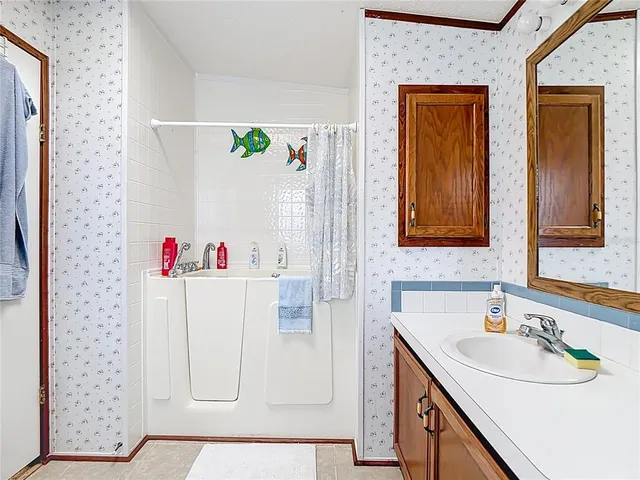a bathroom with a sink vanity and a mirror