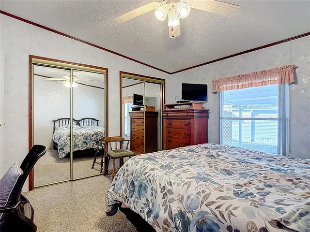 a bed room with a bed and a television