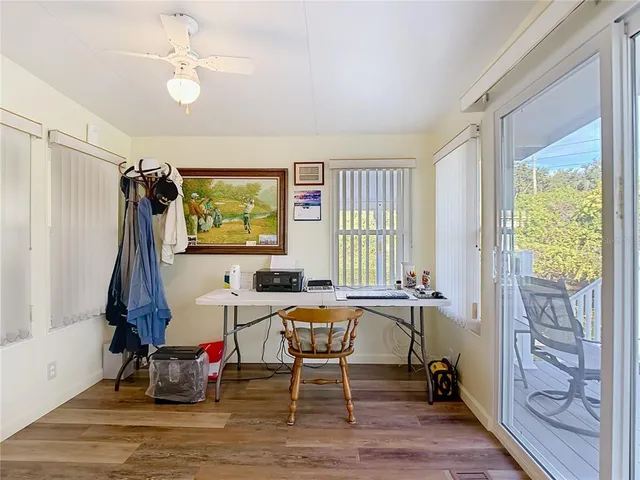 a living room with furniture a window and a flat screen tv