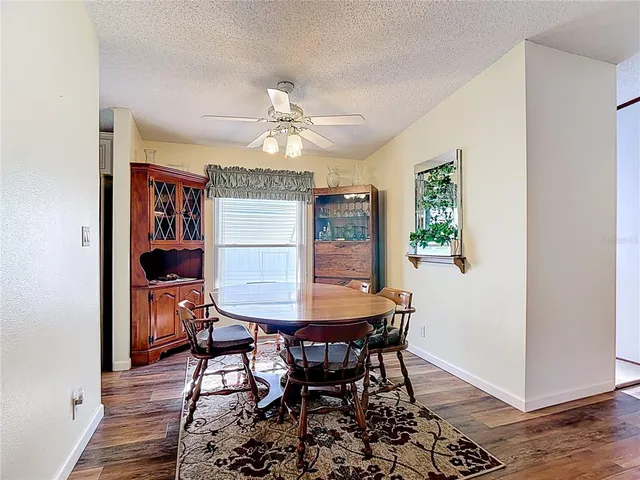 a view of a dining room with furniture and chandelier
