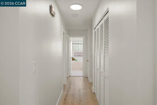 a view of a hallway with wooden floor