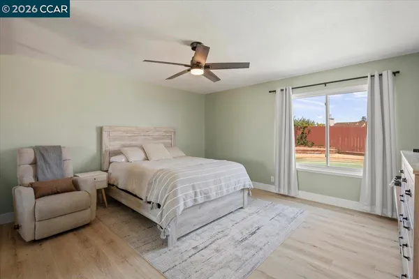a bedroom with a large bed and a window