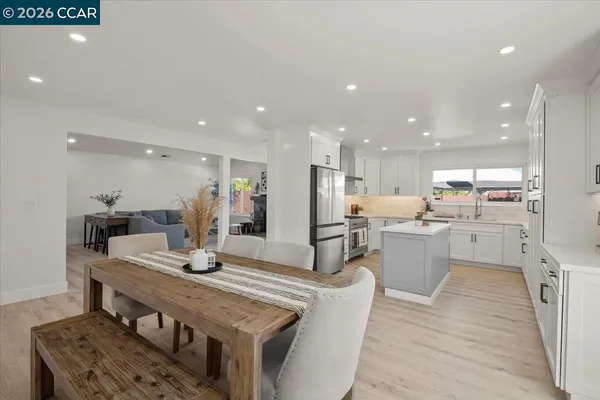 a large kitchen with a table and chairs