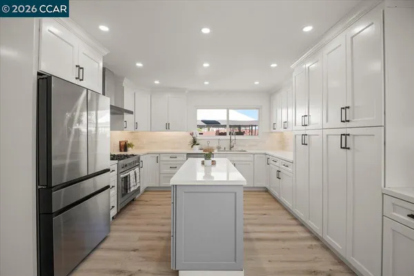a kitchen with refrigerator cabinets and a sink