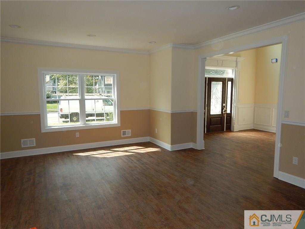 62 Idlewild Road Edison, NJ 08817 - Photo 4 of 11 wooden floor in an empty room with a window