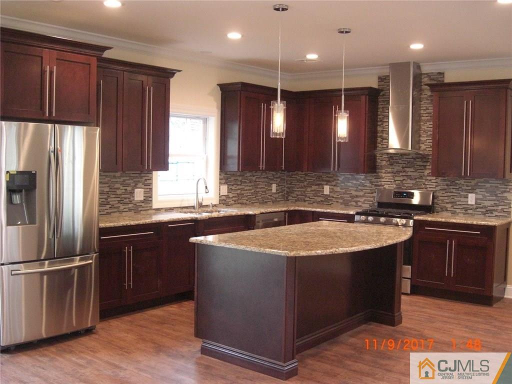 62 Idlewild Road Edison, NJ 08817 - Photo 5 of 11 a kitchen with stainless steel appliances granite countertop a sink stove and refrigerator