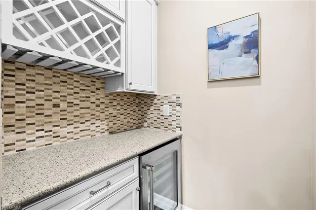 a bathroom with a granite countertop sink a mirror and shower