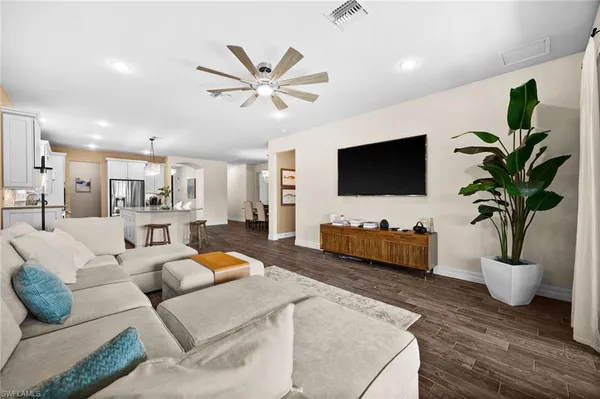 a living room with furniture and a flat screen tv
