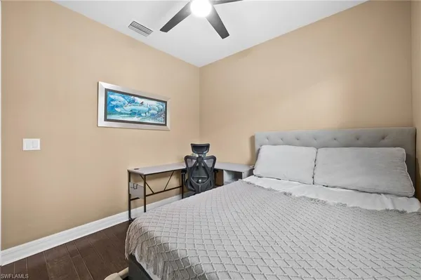 a bedroom with a bed and a wall painting