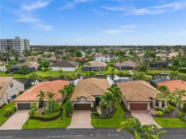 an aerial view of multiple houses with yard