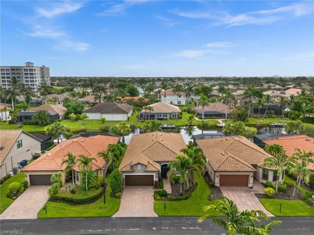 an aerial view of multiple houses with yard