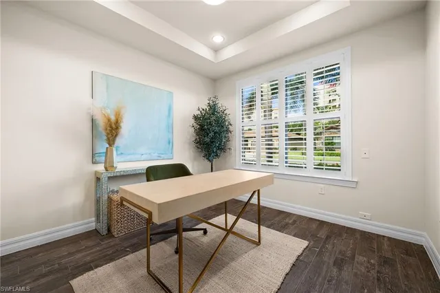 a view of a workspace with furniture and a window