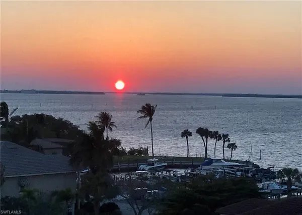 a view of a lake with sunset