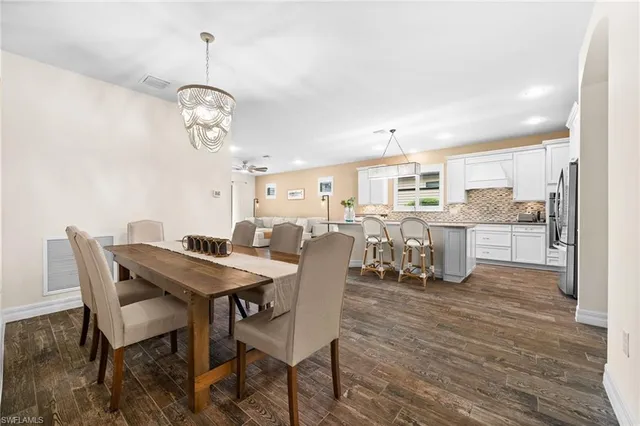 a view of a dining room with furniture wooden floor and chandelier