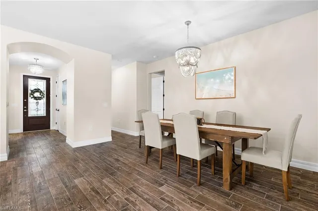 a view of a dining room with furniture wooden floor and chandelier