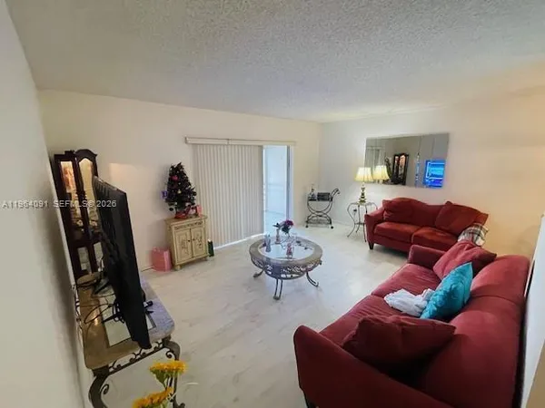 a living room with furniture a window and gym equipment