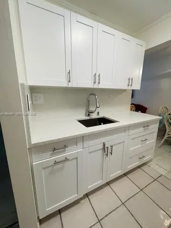 a kitchen with white cabinets
