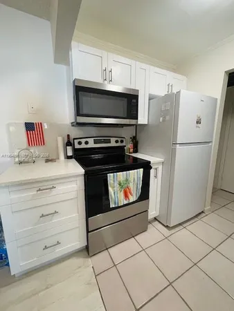 a kitchen with appliances and cabinets