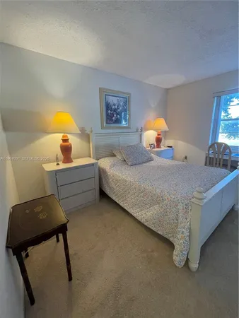 a bedroom with furniture and a lamp