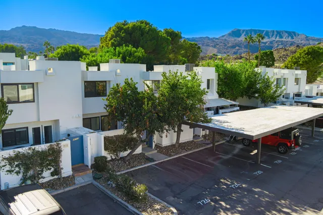 a view of a patio with table and chairs with wooden floor and a yard