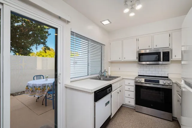 a kitchen with a stove a sink and a microwave