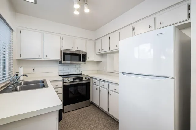 a white refrigerator freezer sitting in a kitchen