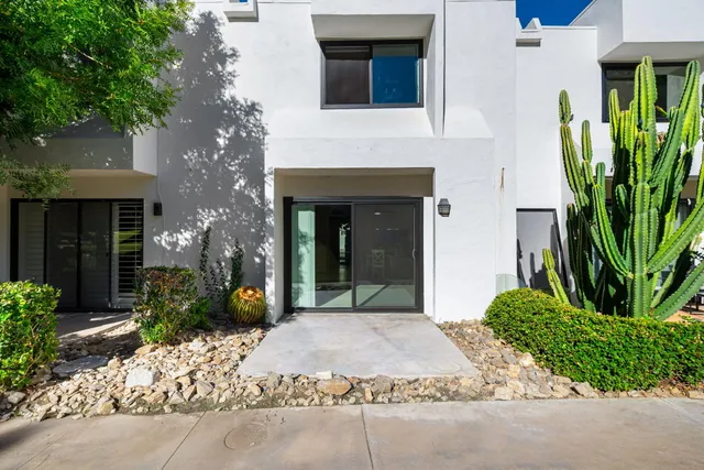 a view of a room with wooden floor and a bathroom