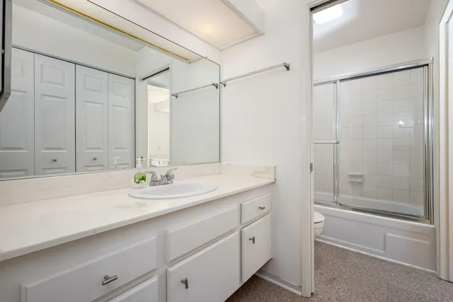 a view of a room with wooden floor and a bathroom
