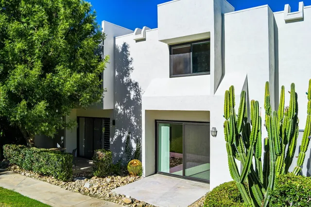 a view of a house with potted plants