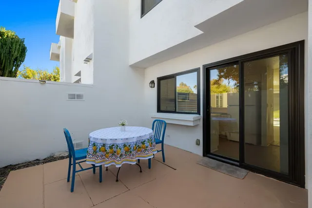 a dining room with furniture and a floor to ceiling window