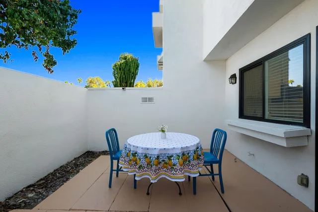 a view of a dining room with furniture and a potted plant