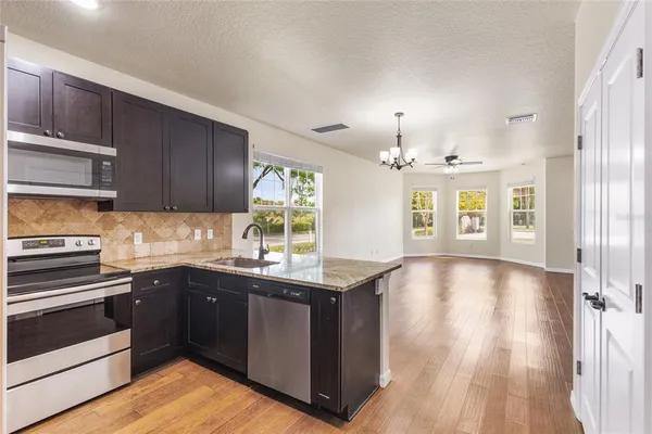 a kitchen with a sink stove and cabinets