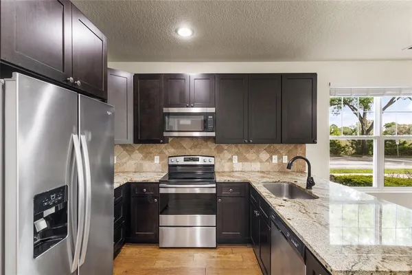 a kitchen with a refrigerator sink and stove
