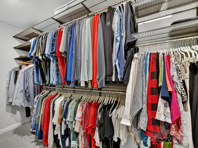 a view of walk in closet with clothes